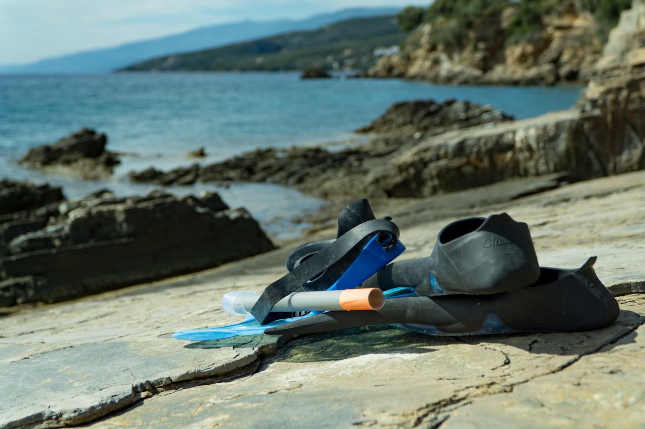 Snorkeling gear on a rocky seaside, perfect for adventures and exploring nature.